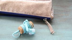 earbuds wrapped around wine cork