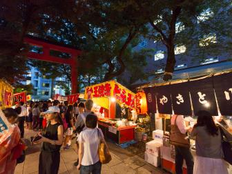 Tokyo, Japan - August 2, 2016 : People walking on the road during the Summer Festival in Hanazono Shrine, Shinjuku, Tokyo, Japan. Many street vendors with games and selling Japanese festival food.
