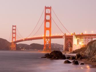 The iconic bridge is illuminated as the sun sets over San Francisco in the western USA