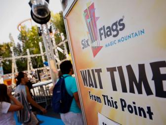 Visitors wait in line to ride a roller coaster at Six Flags Magic Mountain in Valencia, California, U.S., on Monday, April 20, 2015. Six Flags Entertainment Corp. is scheduled to release earnings figures on April 22. Photographer: Patrick T. Fallon/Bloomberg via Getty Images