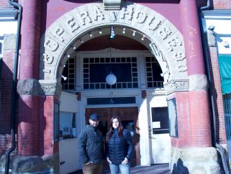 Hosts Jack Osbourne and Katrina Weidman posing in front of the entrance to Twin City Opera House in Ohio. As seen on Travel Channel's Portals To Hell.